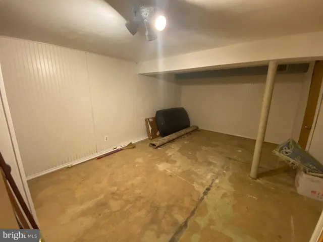 a view of a room with wooden floor and white walls