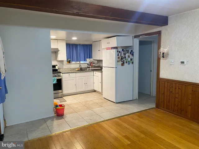 a kitchen with refrigerator and cabinets
