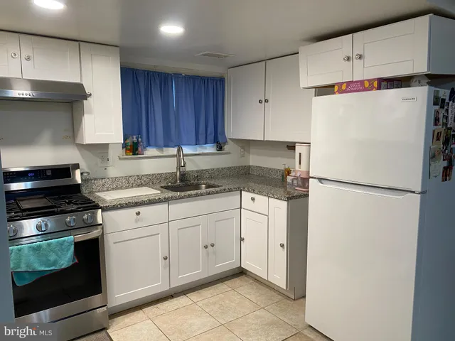 a white refrigerator freezer sitting in a kitchen