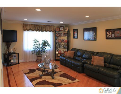 417 Plainfield Road Edison, NJ 08820 - Photo 11 of 14 a living room with furniture a dining table and a flat screen tv