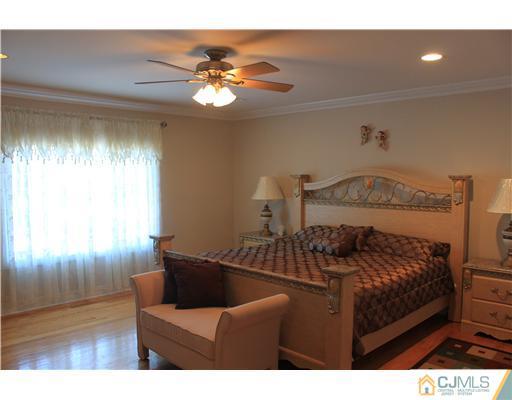 417 Plainfield Road Edison, NJ 08820 - Photo 13 of 14 a bedroom with a bed and a chandelier