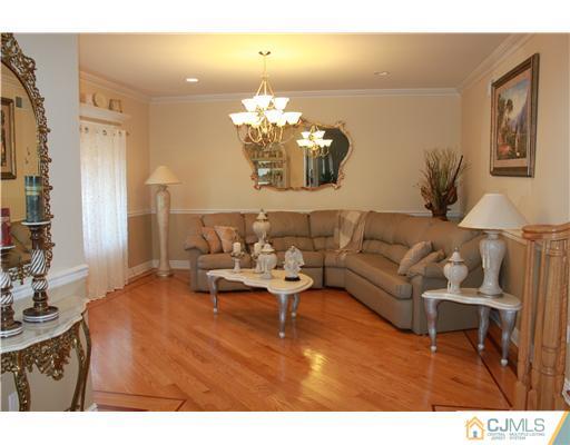 417 Plainfield Road Edison, NJ 08820 - Photo 4 of 14 a living room with furniture and a chandelier