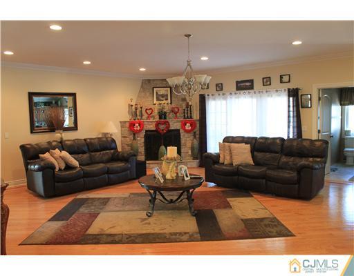 417 Plainfield Road Edison, NJ 08820 - Photo 6 of 14 a living room with furniture and a wooden floor
