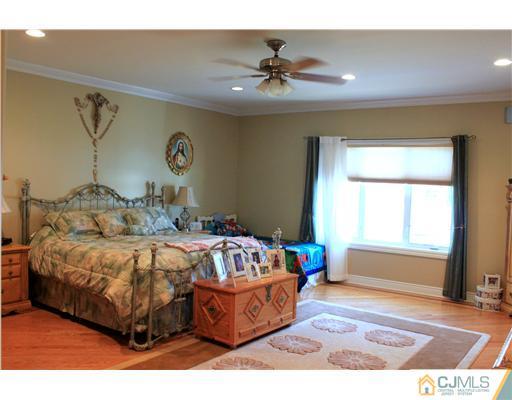 417 Plainfield Road Edison, NJ 08820 - Photo 7 of 14 a bedroom with a bed and a window