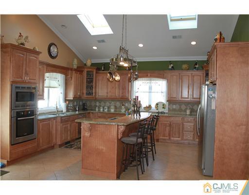 417 Plainfield Road Edison, NJ 08820 - Photo 8 of 14 a kitchen with cabinets and refrigerator