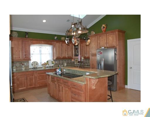 417 Plainfield Road Edison, NJ 08820 - Photo 9 of 14 a kitchen with stainless steel appliances granite countertop a sink refrigerator and microwave