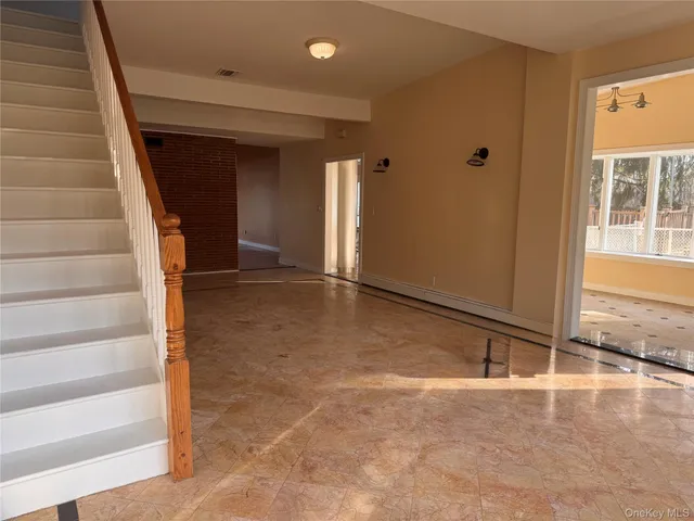 a view of an empty room with stairs