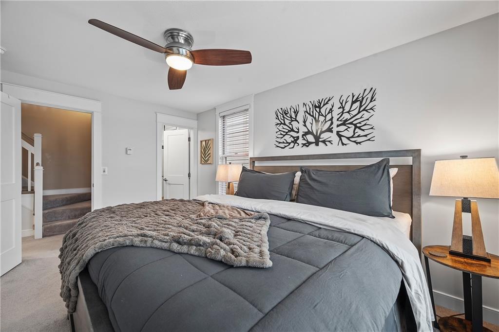 706 Ivy Street, Unit 2 Pittsburgh, PA 15232 - Photo 25 of 35 a bedroom with a large bed and a chandelier