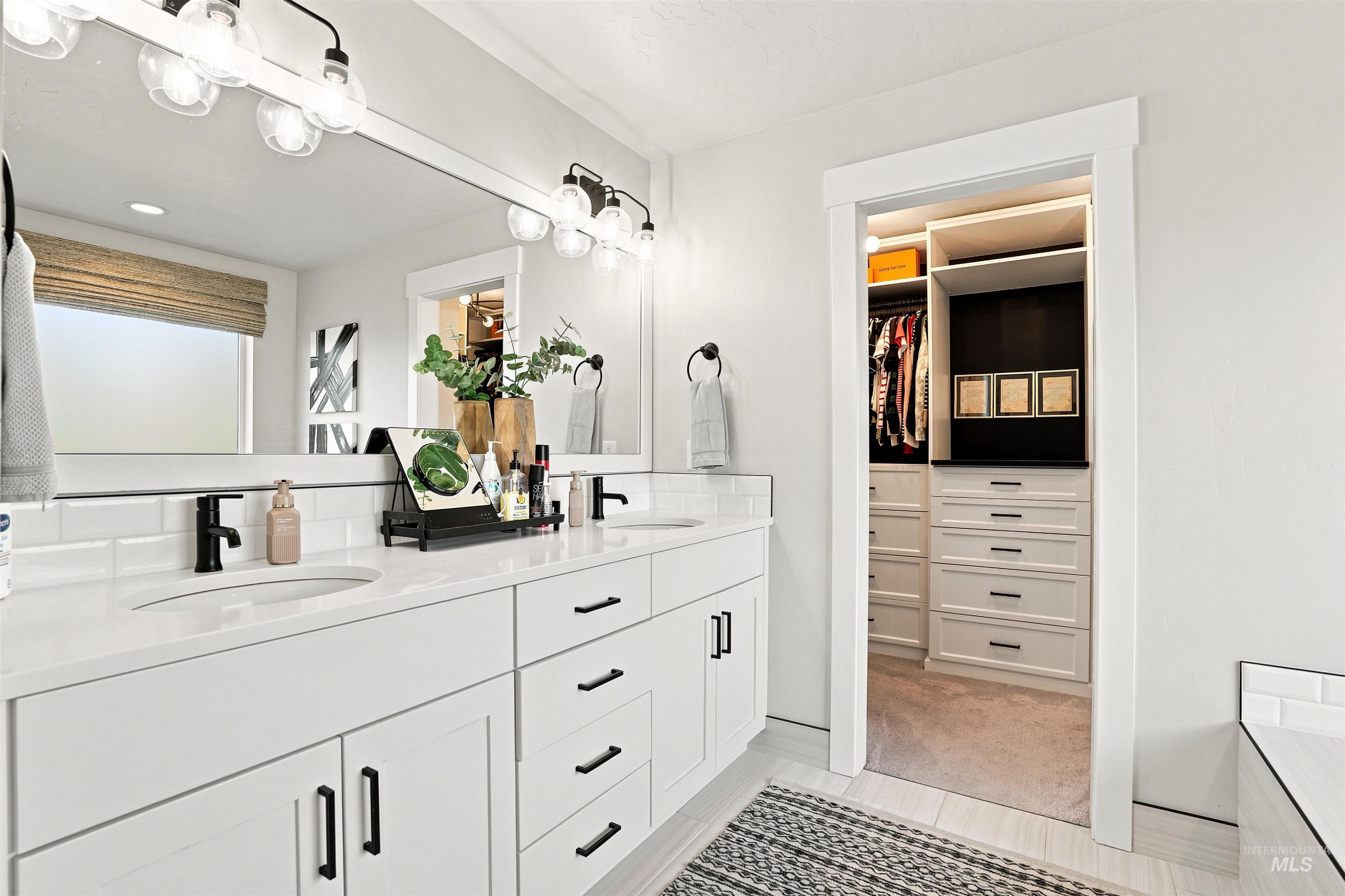 4323 West Ladle Rpds Drive Meridian, ID 83646 - Photo 22 of 49 Bathroom featuring a dual vanity with white cabinetry, white countertops, and matte black fixtures