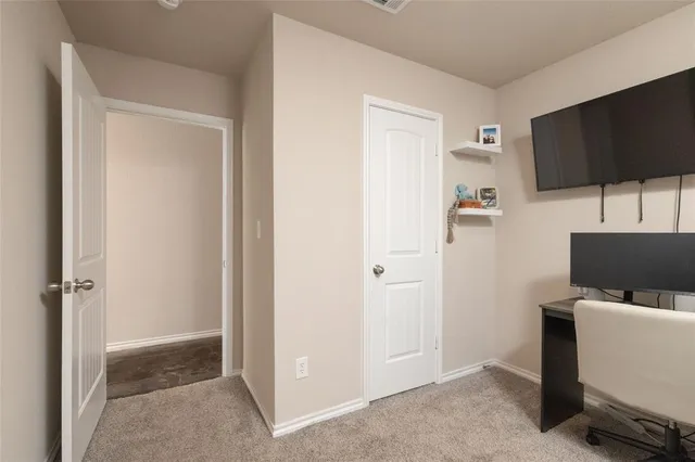 a view of a workspace with furniture and a flat screen tv