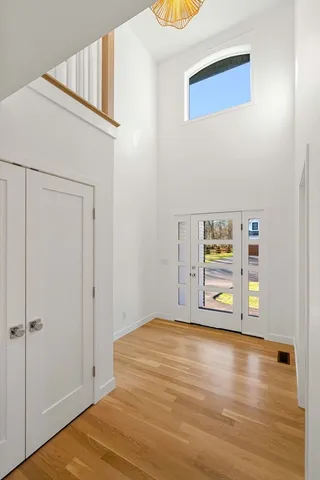 a view of a bedroom with wooden floor and closet
