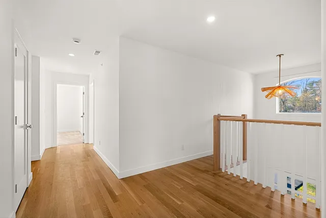 a view of hallway with wooden floor