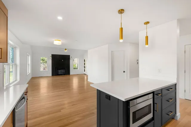 a view of a kitchen with wooden floor and a sink