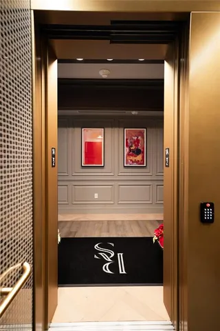 a dining room with furniture a chandelier and a flat screen tv