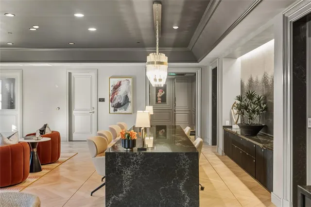 a large kitchen with kitchen island a dining table and chairs