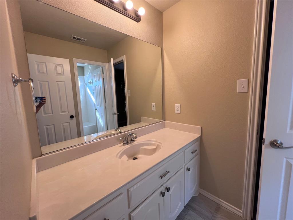 8158 Painted Tree Trail Fort Worth, TX 76131 - Photo 14 of 18 a bathroom with a sink and a mirror
