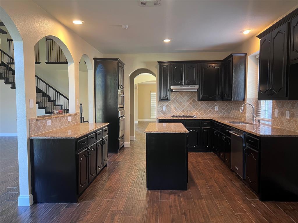 8158 Painted Tree Trail Fort Worth, TX 76131 - Photo 5 of 18 a kitchen with a sink and wooden cabinets