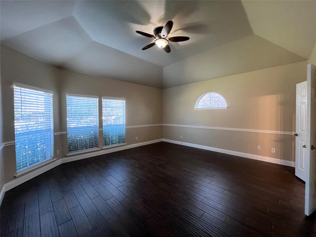 8158 Painted Tree Trail Fort Worth, TX 76131 - Photo 7 of 18 a view of an empty room with wooden floor and a window