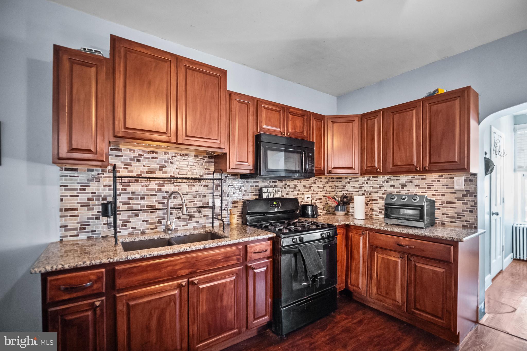 614 Maple Street Reading, PA 19602 - Photo 11 of 23 a kitchen with stainless steel appliances granite countertop wooden cabinets a stove top oven a sink and dishwasher