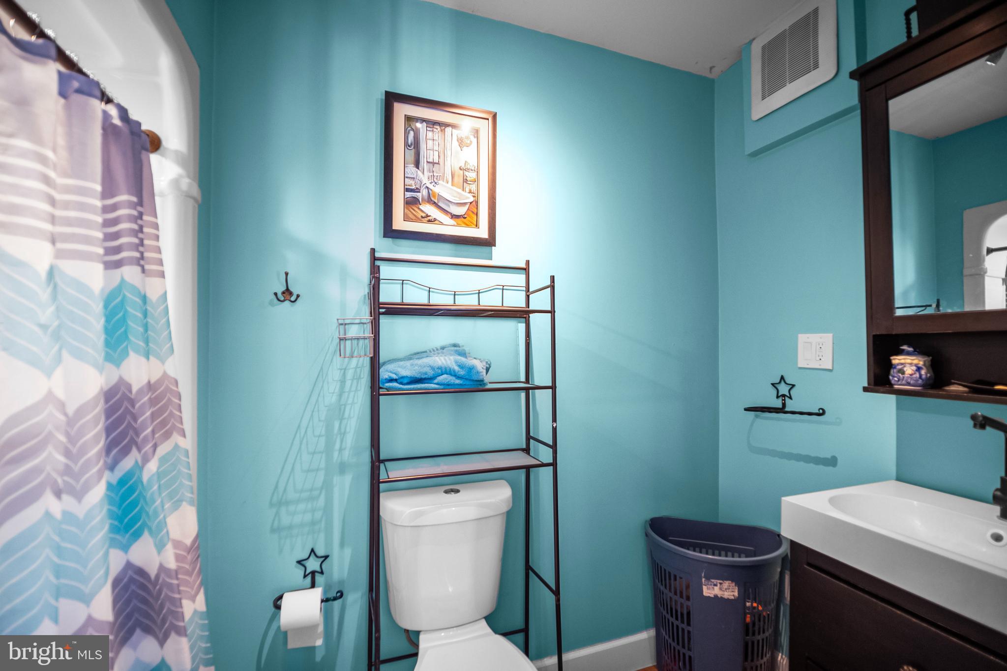 614 Maple Street Reading, PA 19602 - Photo 13 of 23 a bathroom with a toilet sink and mirror