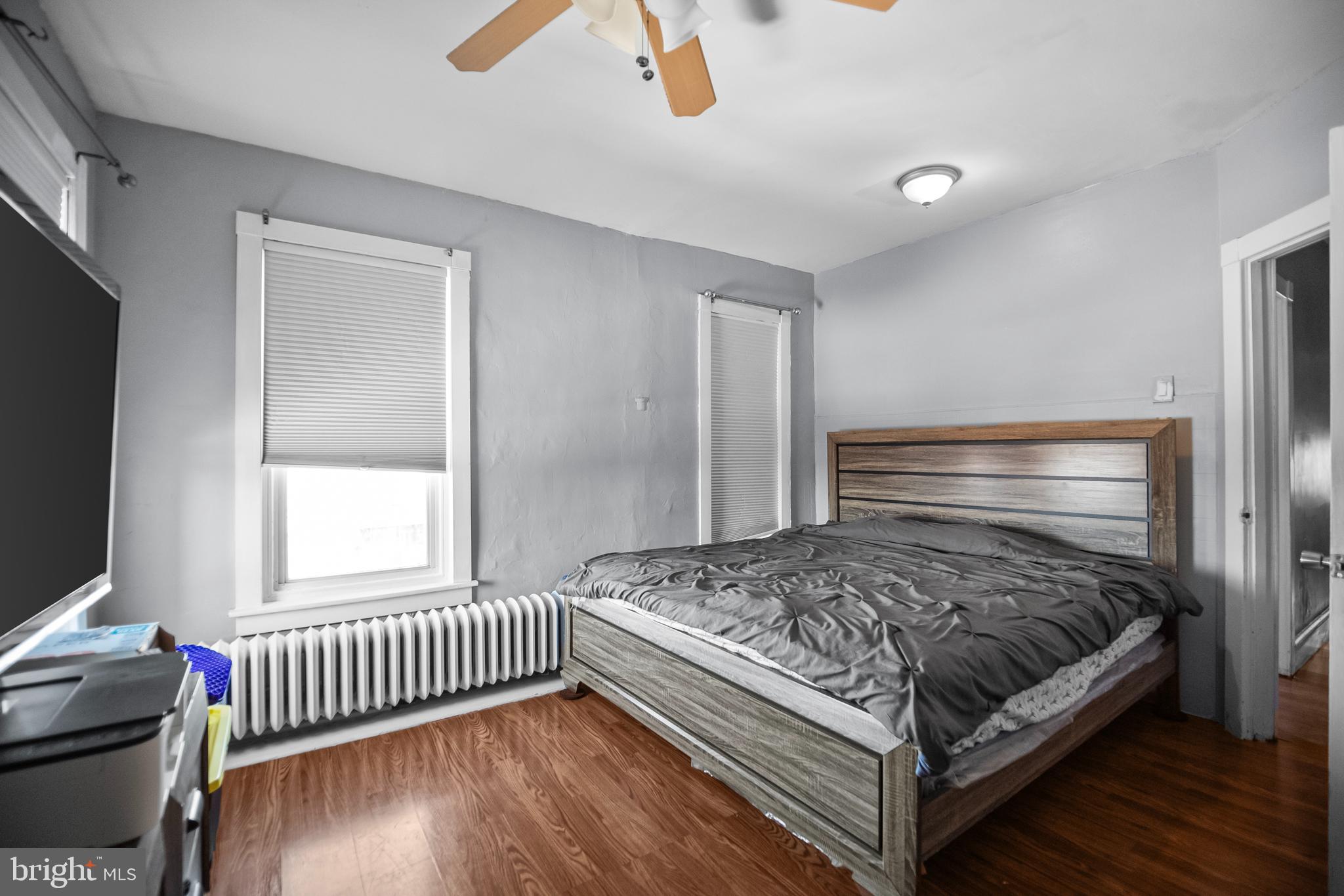 614 Maple Street Reading, PA 19602 - Photo 14 of 23 a bedroom with a bed and wooden floor