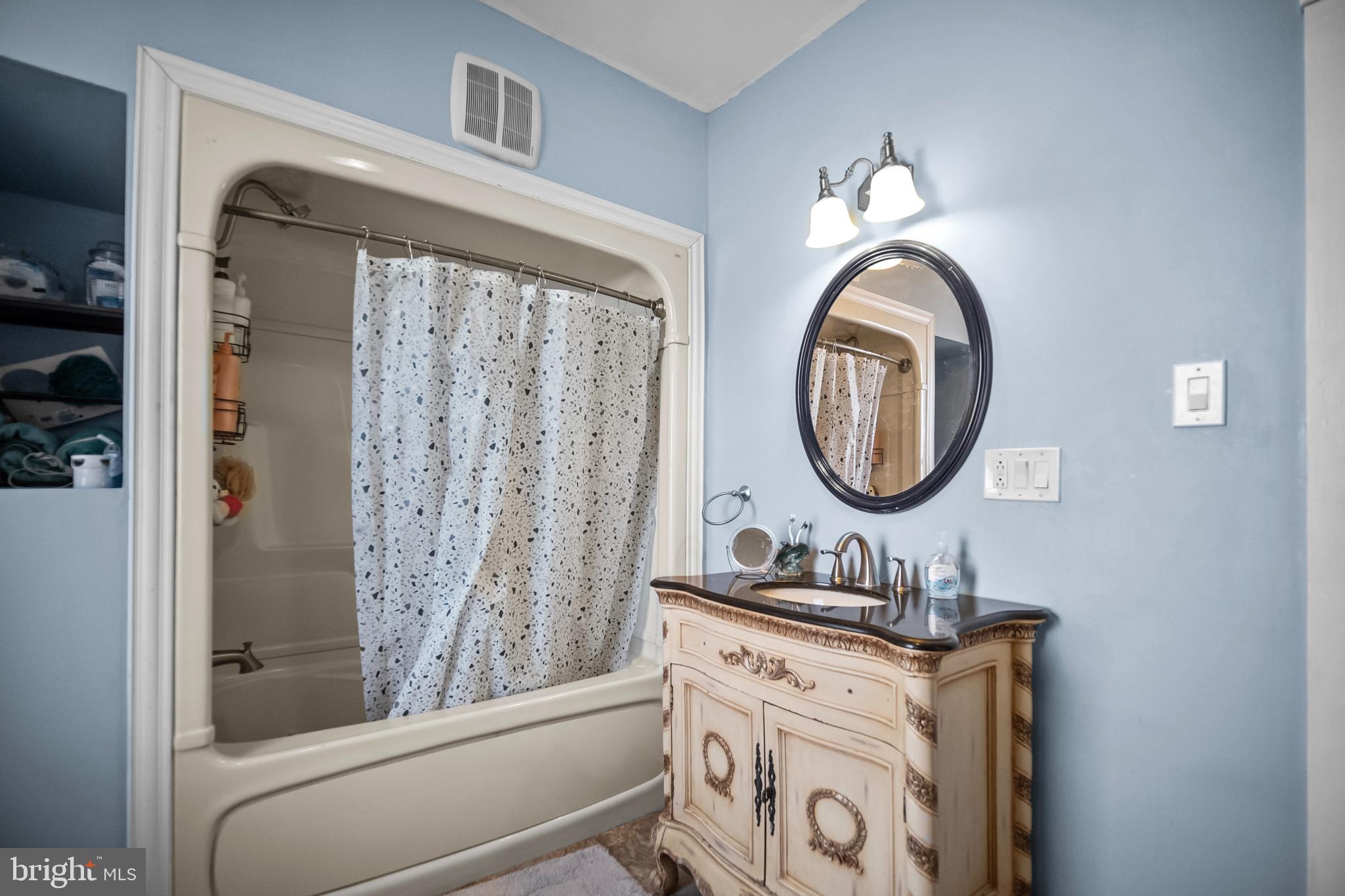 614 Maple Street Reading, PA 19602 - Photo 16 of 23 a bathroom with a sink and a mirror