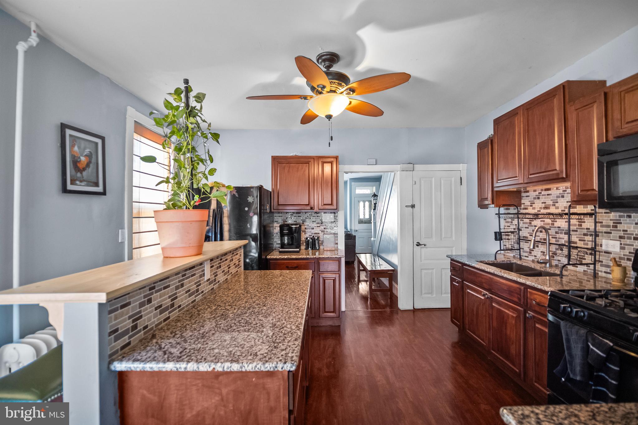 614 Maple Street Reading, PA 19602 - Photo 8 of 23 a kitchen with stainless steel appliances granite countertop a stove top oven a sink dishwasher and a stove with wooden floor