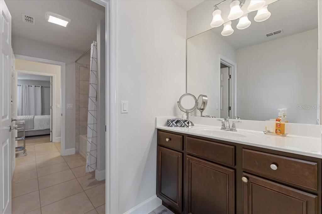 7180 Beek Street Windermere, FL 34786 - Photo 21 of 33 a en suite bathroom with a double vanity sink and a mirror