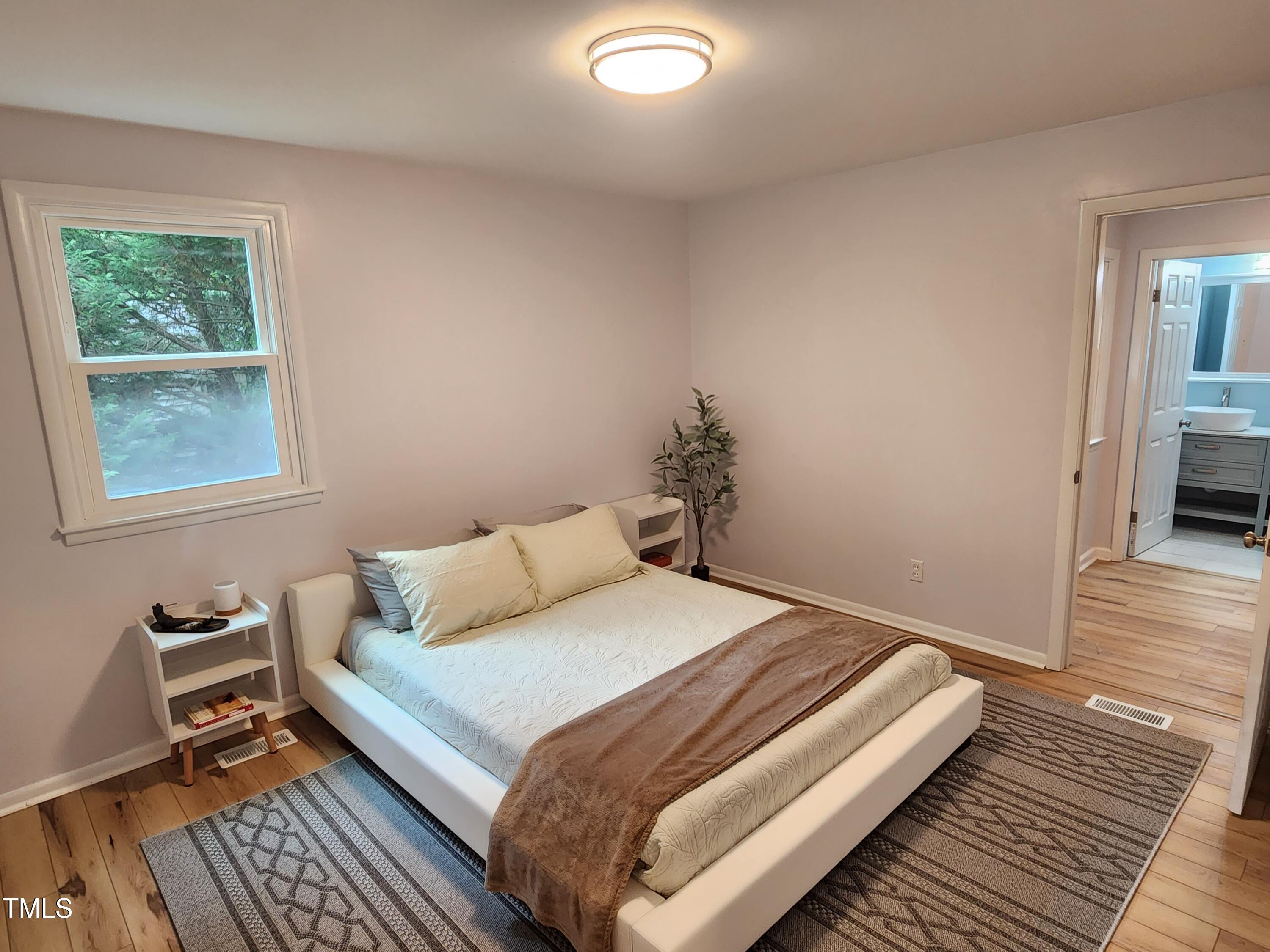 427 Ridgefield Road Chapel Hill, NC 27517 - Photo 13 of 27 a bedroom with a bed and wooden floor