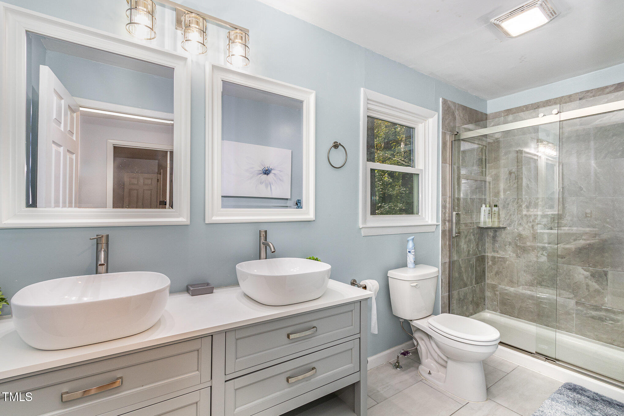 427 Ridgefield Road Chapel Hill, NC 27517 - Photo 15 of 27 a bathroom with a toilet a sink a mirror a shower a vanity and window