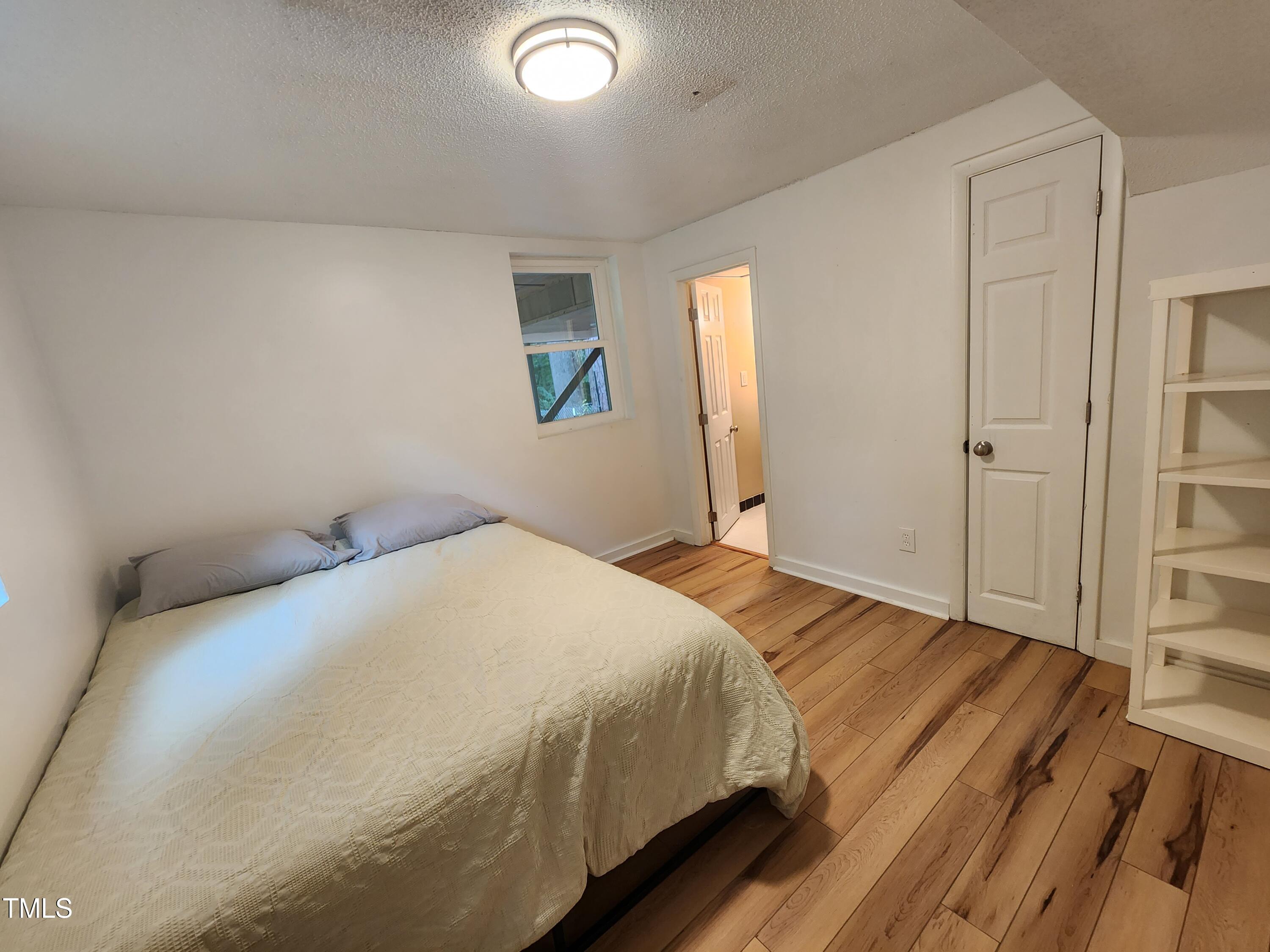 427 Ridgefield Road Chapel Hill, NC 27517 - Photo 22 of 27 a bedroom with a bed and a window