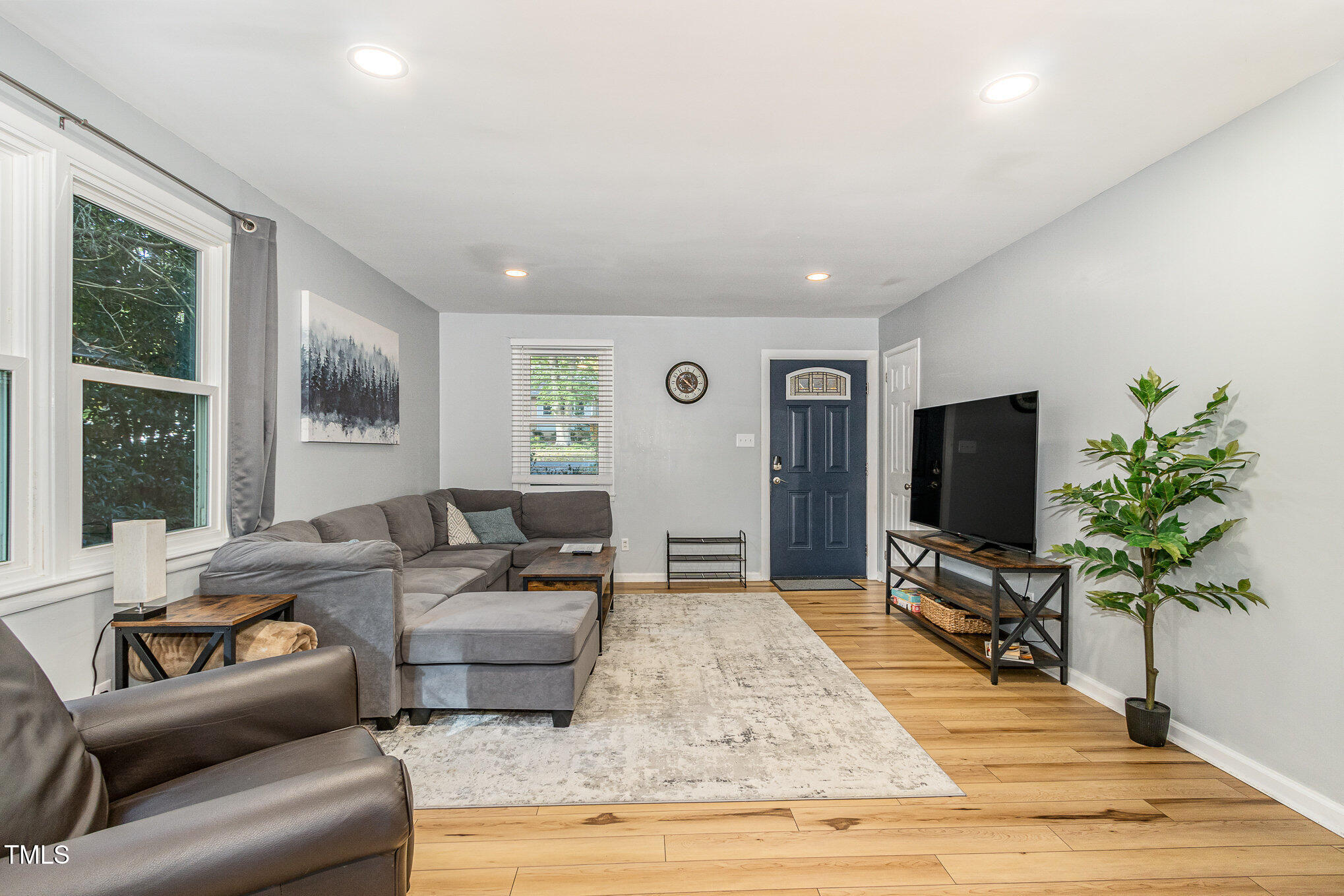 427 Ridgefield Road Chapel Hill, NC 27517 - Photo 5 of 27 a living room with furniture and a flat screen tv