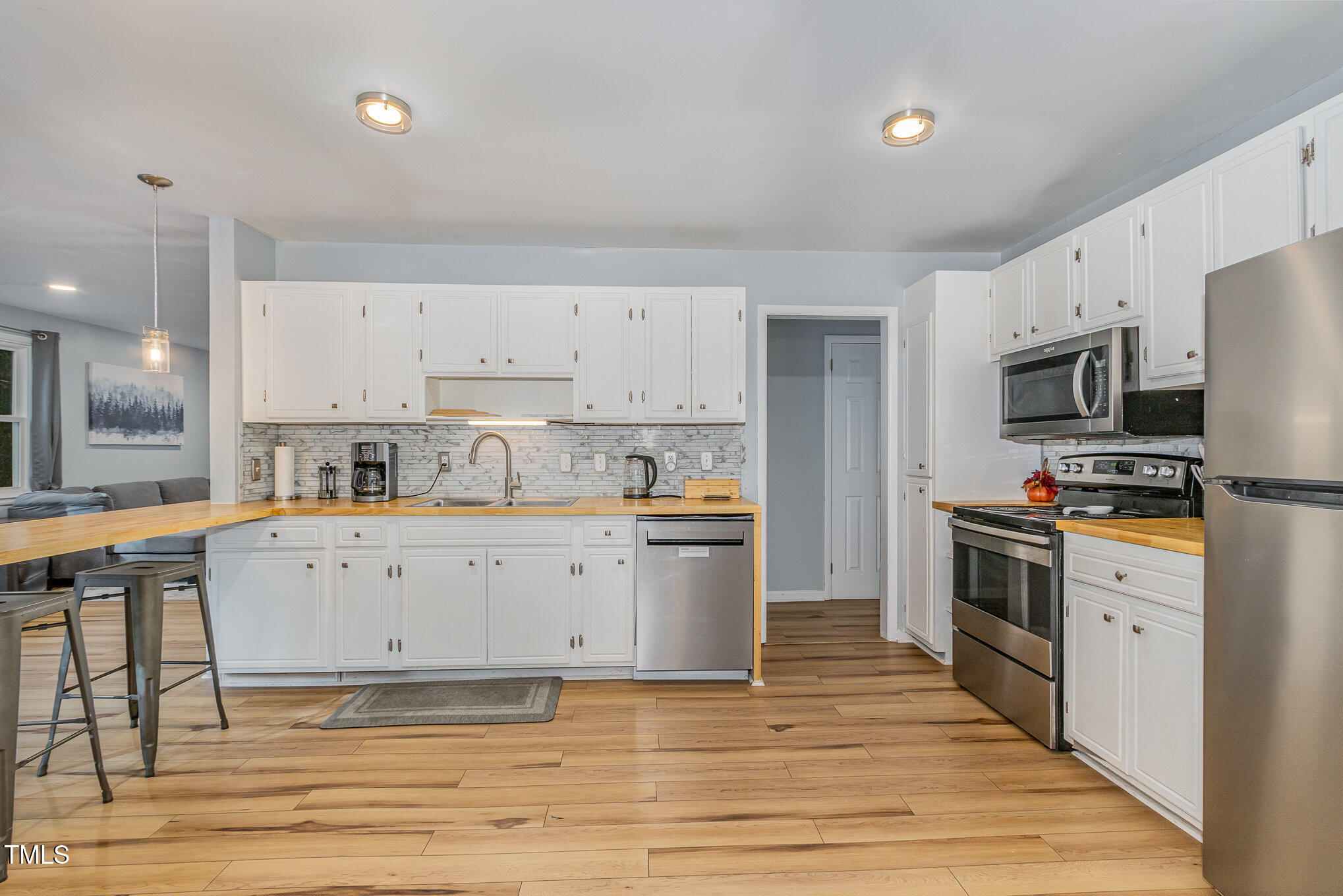 427 Ridgefield Road Chapel Hill, NC 27517 - Photo 10 of 27 a kitchen with stainless steel appliances a stove top oven a refrigerator cabinets and a center island