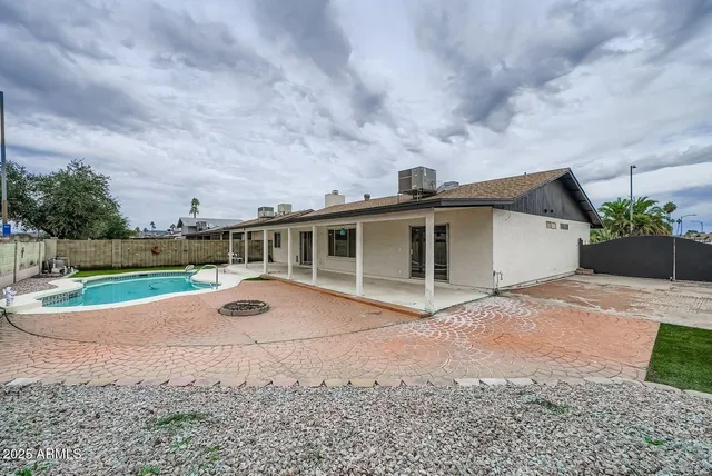 a front view of house with yard and car parked