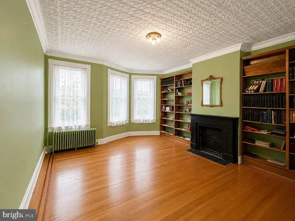 a view of an empty room with a fireplace and a window