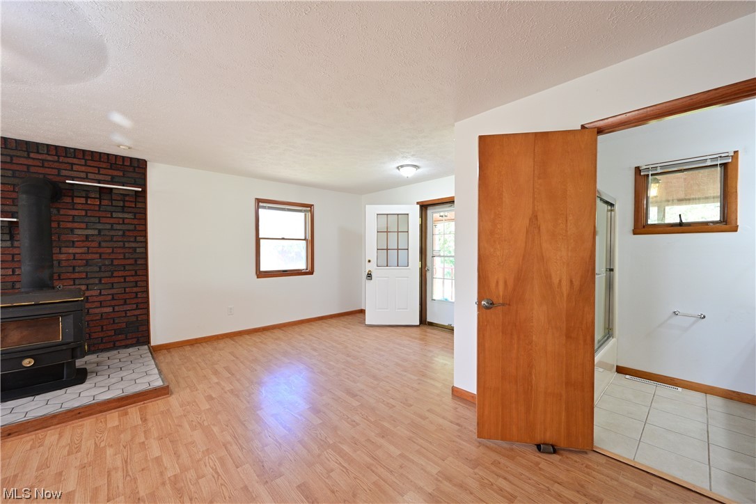 8280 Lafayette Road Lodi, OH 44254 - Photo 14 of 35 Tiled living room with lofted ceiling and a textured ceiling