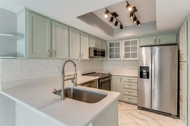 a kitchen with granite countertop a sink and cabinets