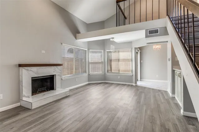 a view of entryway with wooden floor and a fireplace