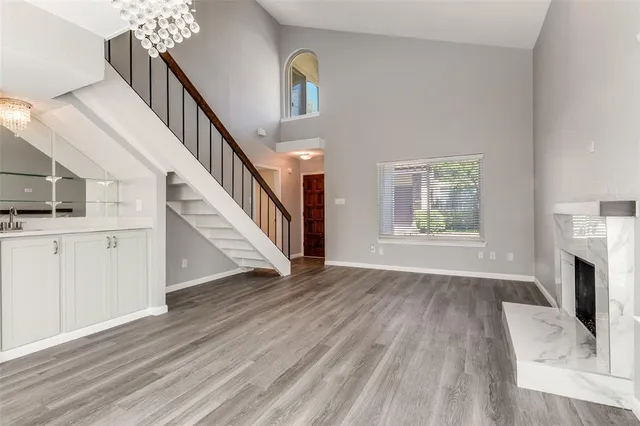 a view of an empty room with a window and fireplace