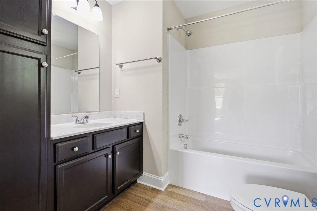 17557 Hewlett Road Beaverdam, VA 23015 - Photo 25 of 29 a bathroom with a sink and mirror with bathtub