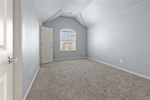 an empty room with a window and a ceiling fan