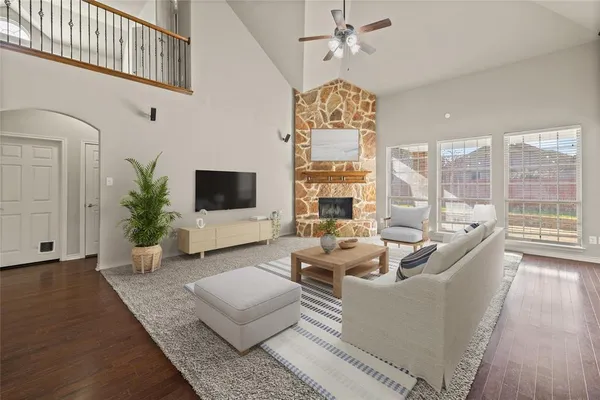 a living room with furniture a flat screen tv and a large window