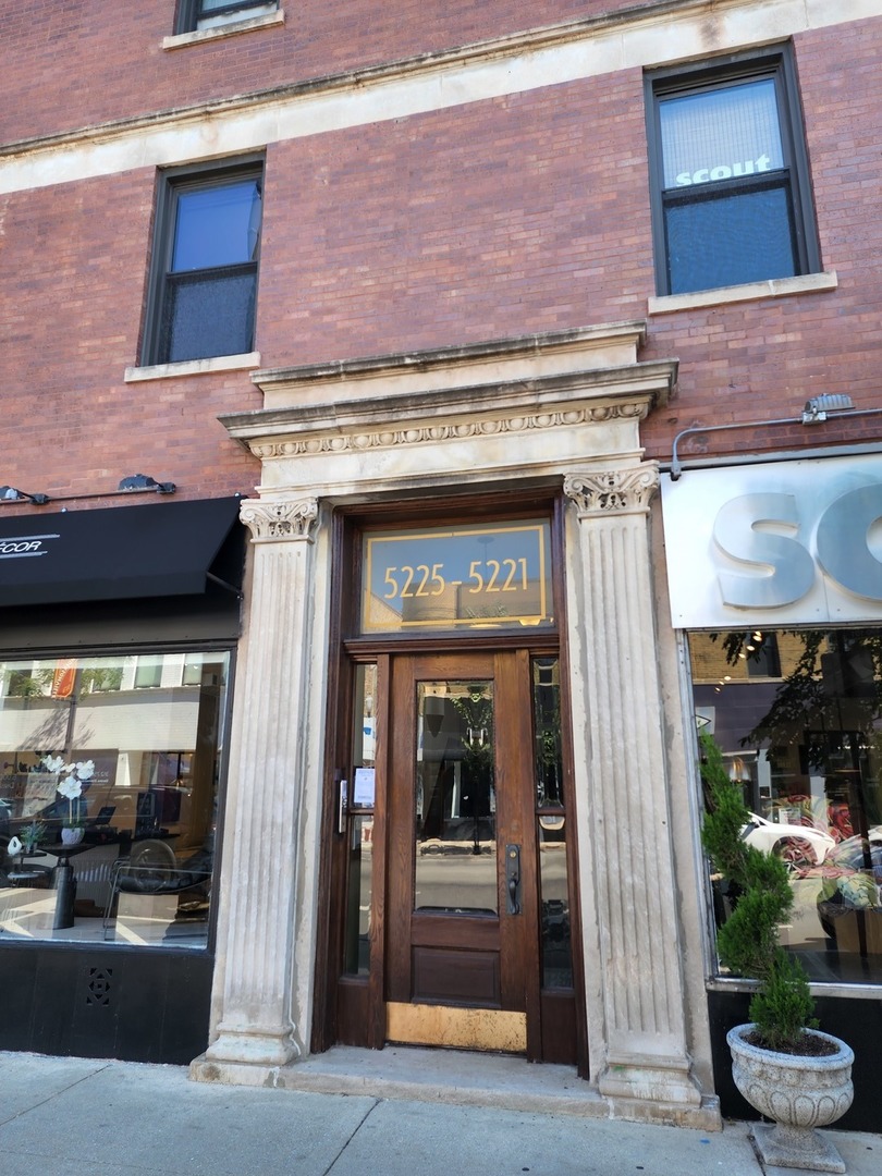 5225 North Clark Street, Unit 2 Chicago, IL 60640 - Photo 1 of 21 a view of a brick building with a bench in front of building
