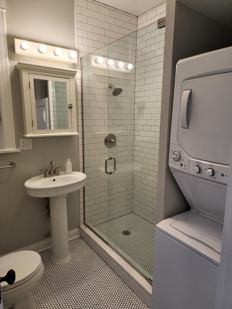 5225 North Clark Street, Unit 2 Chicago, IL 60640 - Photo 11 of 21 a bathroom with a sink a toilet and shower