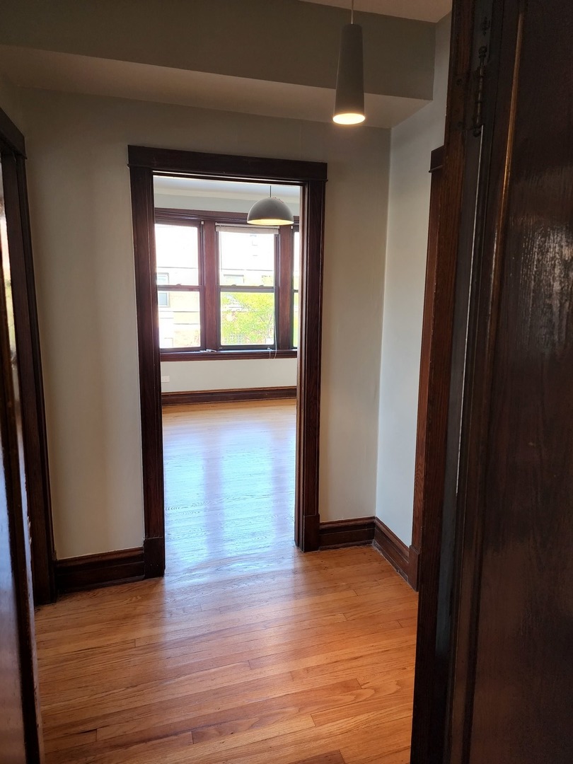 5225 North Clark Street, Unit 2 Chicago, IL 60640 - Photo 15 of 21 a view of empty room with wooden floor and fan