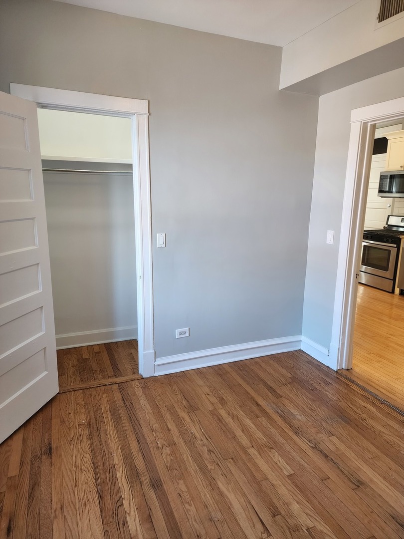 5225 North Clark Street, Unit 2 Chicago, IL 60640 - Photo 20 of 21 wooden floor in an empty room