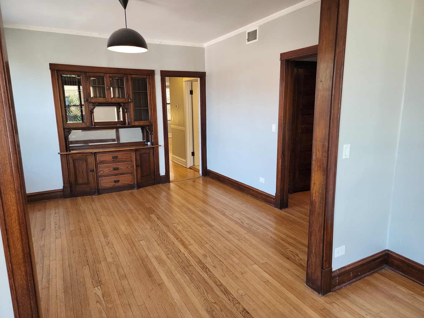 5225 North Clark Street, Unit 2 Chicago, IL 60640 - Photo 5 of 21 a view of an empty room with wooden floor and a window