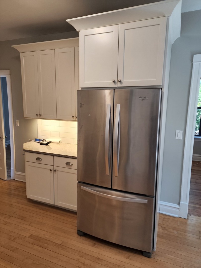 5225 North Clark Street, Unit 2 Chicago, IL 60640 - Photo 9 of 21 a kitchen with appliances a refrigerator and a sink