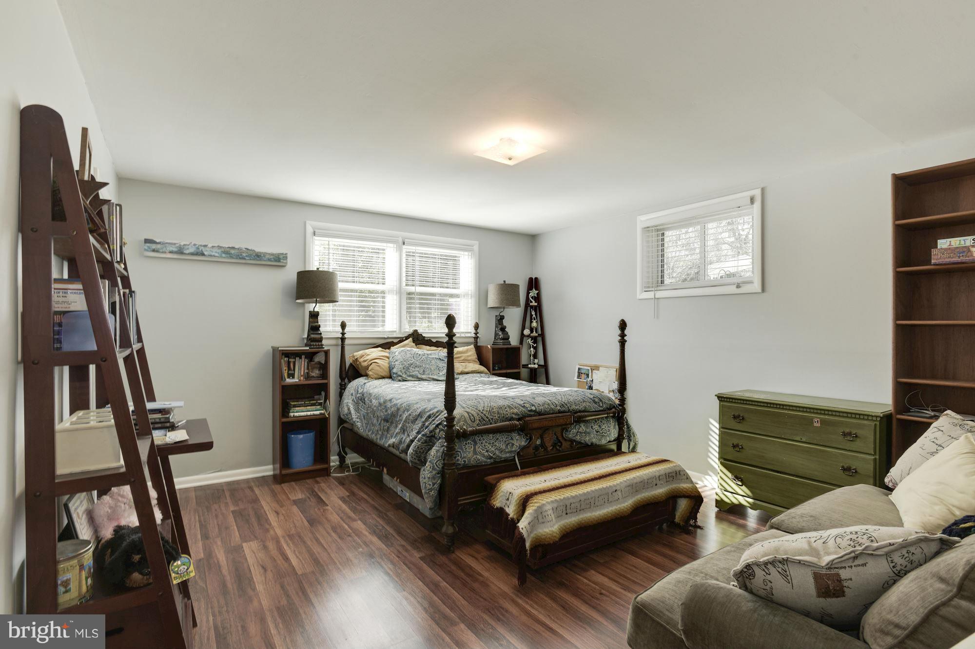 6705 Maxalea Road Baltimore, MD 21239 - Photo 17 of 30 a bedroom with furniture and a book shelf