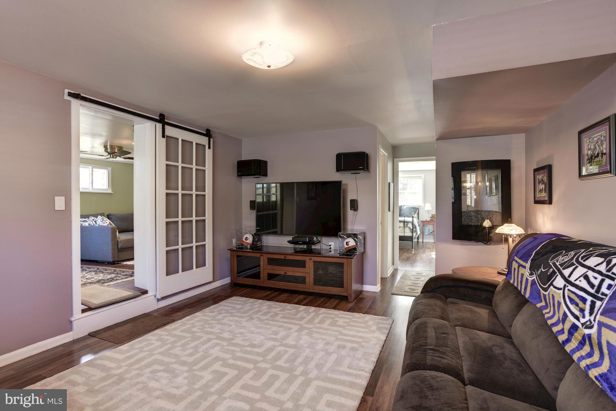 6705 Maxalea Road Baltimore, MD 21239 - Photo 20 of 30 a living room with furniture and a flat screen tv